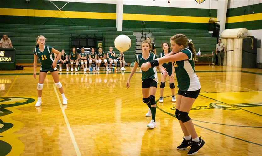 A volleyball player bumps the ball